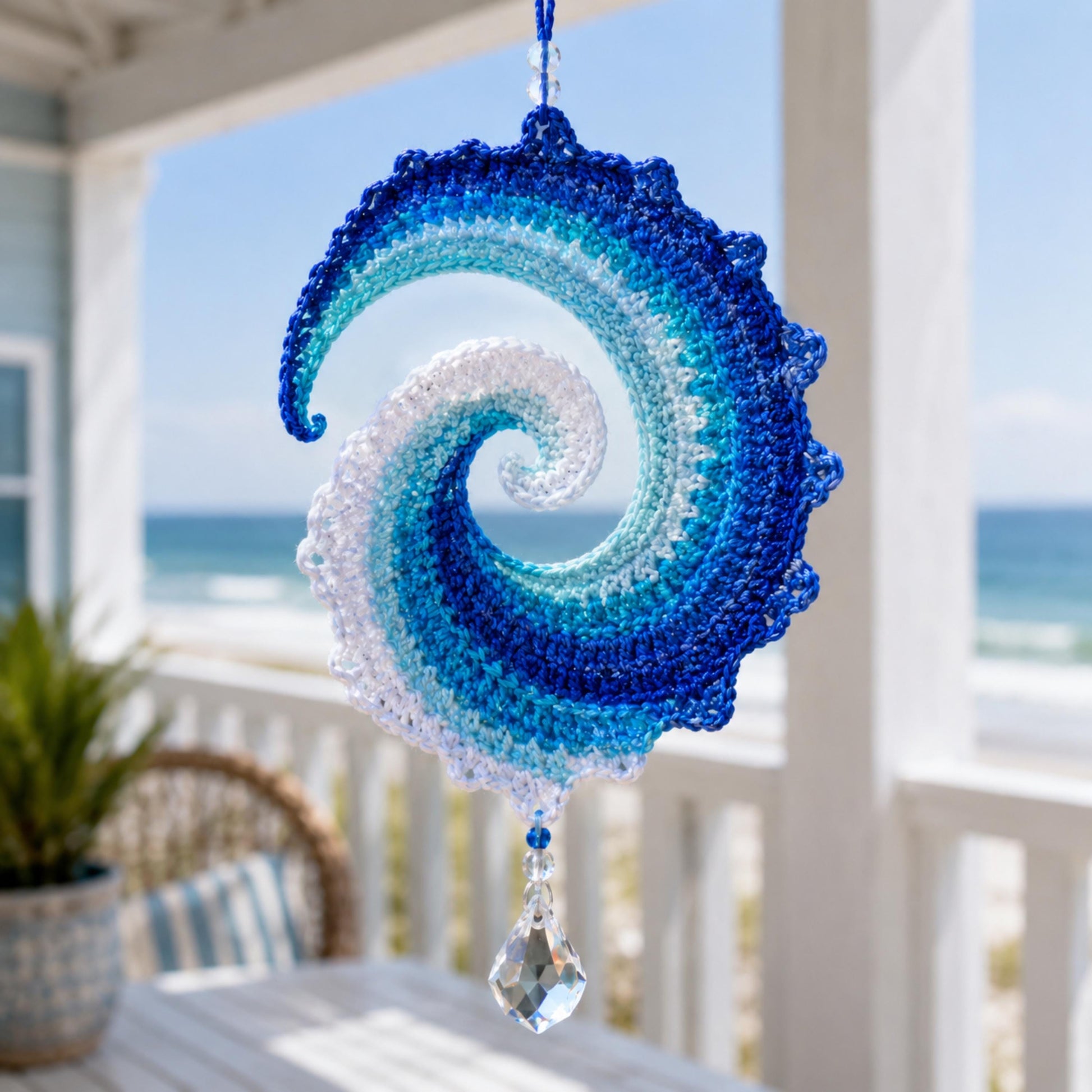 Ocean wave crochet spinner hanging on a covered coastal porch